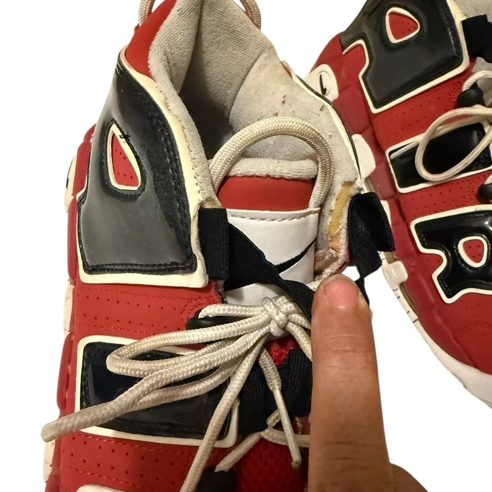 This is a pair of Nike Air More Uptempo '96 basketball shoes in a red, black.
